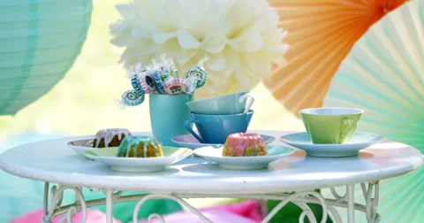 Colorful picnic table with lollipops, tea cups and cakes 2 4K Video stock 44751634
