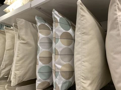 Colorful pillows with different patterns hung from a ceiling wadrobe Stock-Fotos