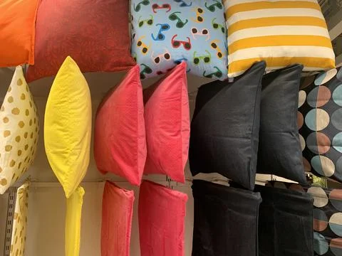 Colorful pillows with different patterns hung from a ceiling wadrobe Stock-Fotos