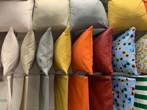 Colorful pillows with different patterns hung from a ceiling wadrobe Stock-Fotos