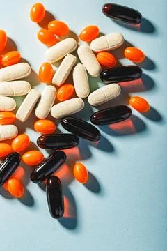 Colorful pills on a blue background. Stock Photos