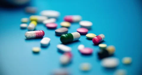 Colorful Pills Scattered on Turquoise Surface - Slider Motion Video stock 308005997