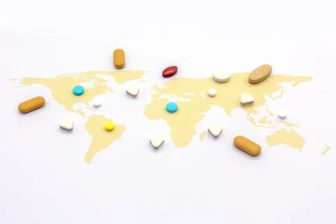 Colorful pills on world map on white blackground Stock Photos
