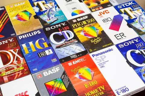 Colorful plastic and paper cases with VHS videotapes. Stock Photos