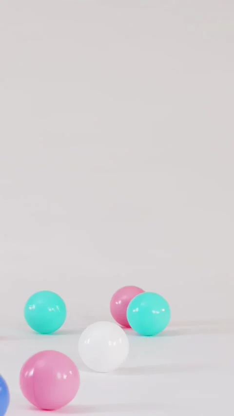 Colorful Plastic Balls Falling and Bouncing on a White Surface 스톡 동영상 328147931