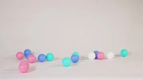 Colorful Plastic Balls Falling and Bouncing on a White Surface 스톡 동영상 328281183
