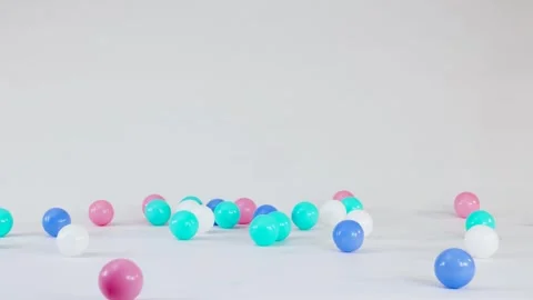 Colorful Plastic Balls Falling and Bouncing on a White Surface 스톡 동영상 328337352