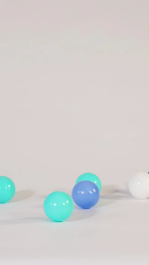 Colorful Plastic Balls Falling and Bouncing on a White Surface 스톡 동영상 328569049