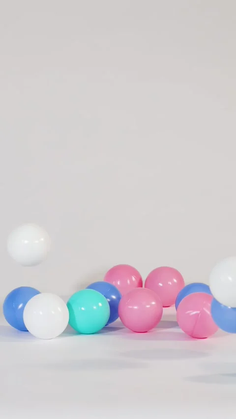 Colorful Plastic Balls Falling and Bouncing on a White Surface 스톡 동영상 328619391
