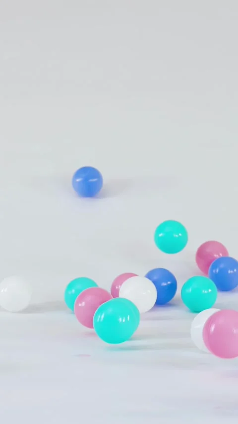 Colorful Plastic Balls Falling and Bouncing on a White Surface 스톡 동영상 328619401