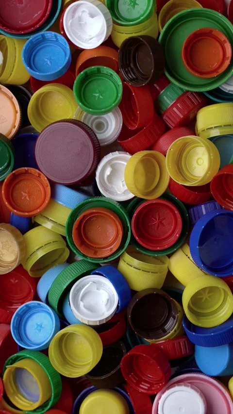 Colorful plastic bottle caps piled together in vibrant hues Stock Footage 342085294