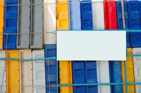 Colorful plastic boxes background and white board - add text Stock Photos