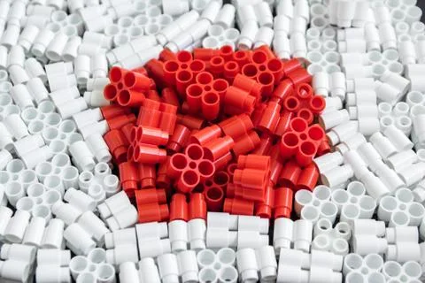Colorful plastic bricks that form the flag of Japan on the background of blac Stock Photos