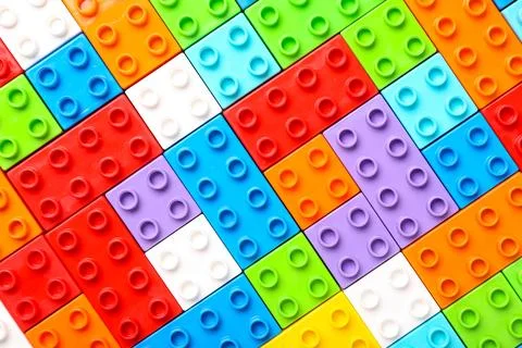 Colorful plastic building blocks as background, closeup Stock Photos