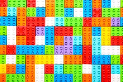 Colorful plastic building blocks as background Stock Photos