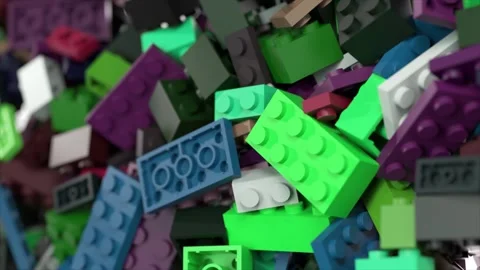 Colorful plastic construction bricks cascading and interlocking dynamically Stock Footage 309991492