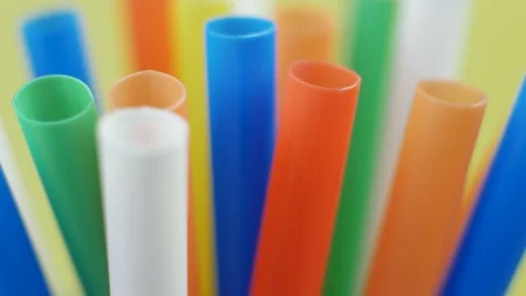 Colorful plastic drinking straws reflect urban lifestyle and disposable culture Stock Footage 313734825