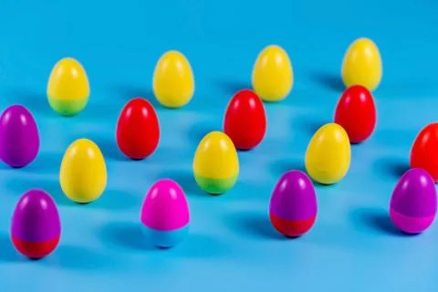 Colorful Plastic Easter Eggs on blue background Stock-Fotos