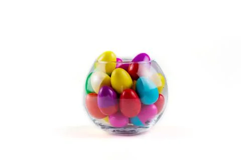Colorful Plastic Easter Eggs in a glass vase on white background Foto stock