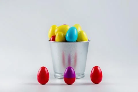 Colorful Plastic Easter Eggs in a metal bucket on white background Stock Photos