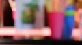Colorful plastic glasses standing on bar counter, barman pouring juice, party HD Footage
