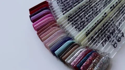 Colorful plastic nail tips with various color nail the table in manicure salon Stock Footage 212311318