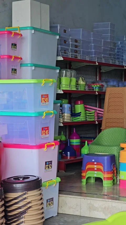 Colorful Plastic Storage Boxes And Chairs Stacked At A Household Goods Store Video stock 340884664