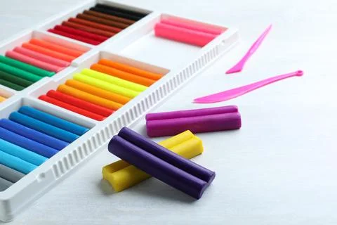 Colorful plasticine and tools on white table Stock Photos