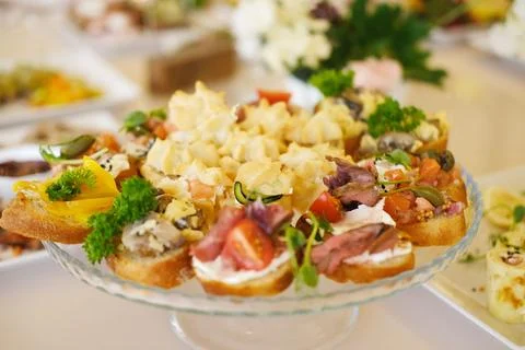 Colorful platter of assorted appetizers featuring various toppings, garnished Stock Photos