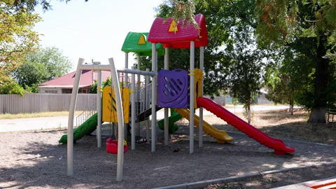 Colorful playground structure featuring slides and climbing frames, showcasing Stock Footage 318711005