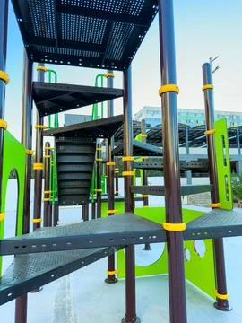 Colorful playground structure with multiple levels and spiral staircase in .. Stock Photos