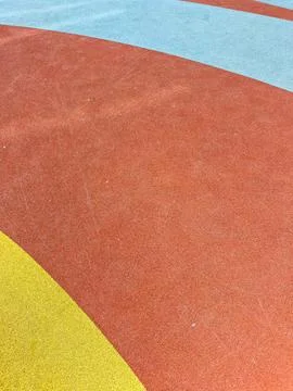 Colorful playground surface with curved patterns designed for children's play Stock Photos