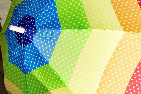 Colorful polka dot patterned umbrella Stock Photos