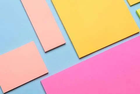 Colorful post-it notes on blue surface for office or study Stock Photos