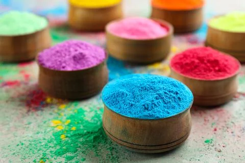 Colorful powder dyes on light background, closeup. Holi festival Stock Photos