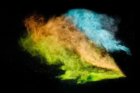 Colorful powder exploding creating vibrant dust cloud Foto stock