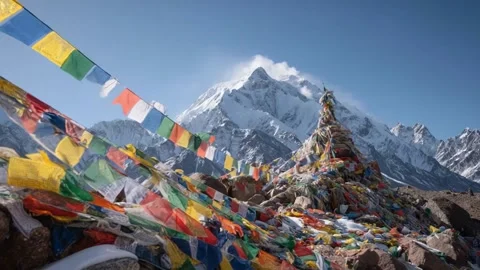 Colorful Prayer Flags Dance in Wind Against Majestic Snow Mountains 스톡 동영상 337513567
