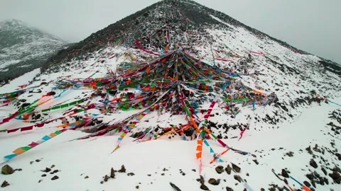 Colorful prayer flags spread over a snowy Sejila Mountain slope Stock Footage 345879480