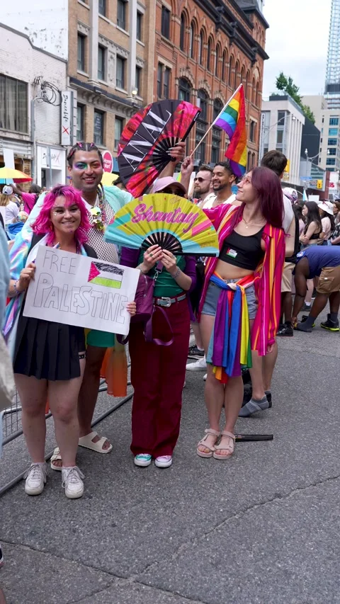 Colorful Pride Parade Group Holding Fans and Free Palestine Sign Toronto Video stock 332018083