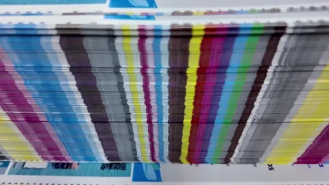 Colorful Printed Paper Stack, show stripes of ink on the edges, side-view shot Stock Footage 314633299