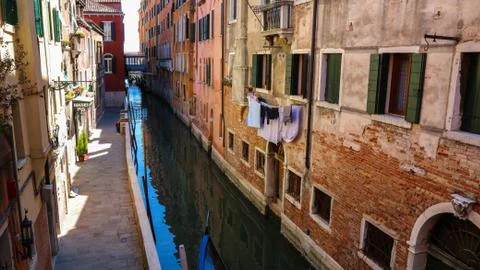 Colorful private canal in Venice, Italy on a sunny day Stock Photos