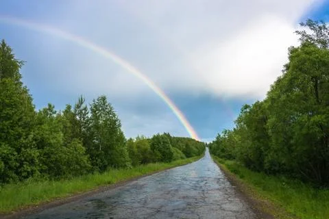 Colorful rainbow over the highway. Stock Photos