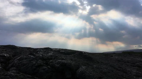 Colorful rays of sunlight over black lava field (4K) Stock Footage 61077171