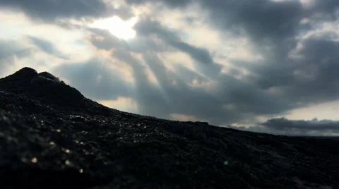 Colorful rays of sunlight over black lava field, timelapse (4K) Stock Footage 61086885