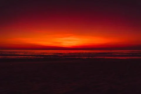 Colorful red bright sky with sunset or sunrise at ocean beach Stock Photos
