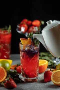 Colorful refreshing drinks for summer, cold strawberry lemonade juice with ice Stock Photos