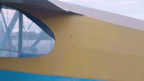 Colorful Retro Single Engine Airplane with Character in Small Airfield Stock Footage 83123548