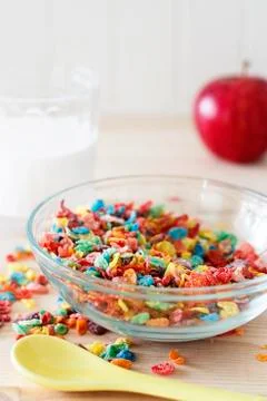 Colorful rice cereal with milk and red apple for children. Healthy breakfast. Stock Photos