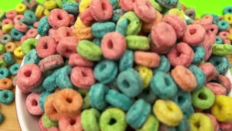 Colorful Ring Shaped Breakfast Cereal Pieces Filling a Bowl in Close Up View Stock Footage 345928043