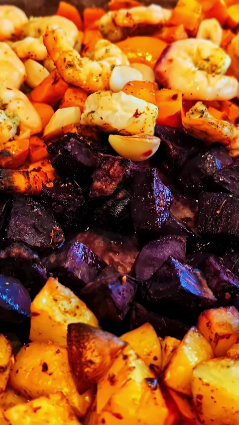 Colorful roasted root vegetables and shrimp with garlic in a baking dish Stock Footage 336717123